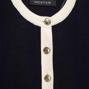 Women's navy blue knit cardigan set with gold anchor buttons and contrast trim