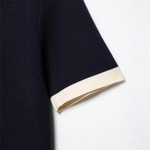 Navy blue knitted top with cream ribbed cuffs and premium textured knit detail