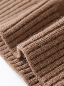 Macro shot of high-quality brown ribbed knit fabric showing soft wool texture and detail