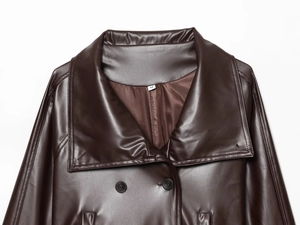 Detailed close-up of dark brown faux leather trench coat collar and M size tag