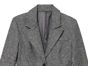 Detail of grey herringbone wool blazer showing notched lapel and single black button