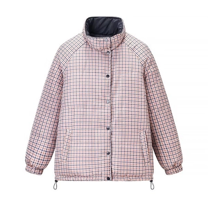 Detail of checkered padded jacket showing windproof stand collar and metal button closure