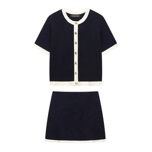 Navy blue two-piece knit set with white contrast trim and gold buttons cardigan and skirt