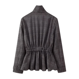 Detail of grey plaid jacket with peplum hem and elastic waist showing wool texture