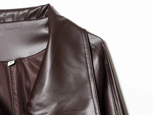 Detail shot of a dark brown faux leather trench coat collar with a size M neck label