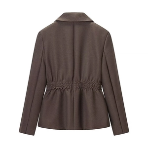 Detail view of brown waffle knit blazer featuring elasticated waist and tailored back seams