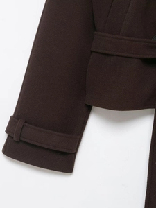 Gros plan du détail du poignet et de la texture du manteau d'hiver en laine marron