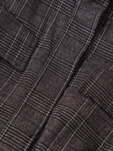 Close-up of the deep brown plaid fabric with blue and white lines on winter jacket suit