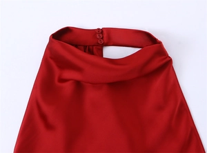 Detail of high neck satin maxi dress with button closure and smooth silk texture