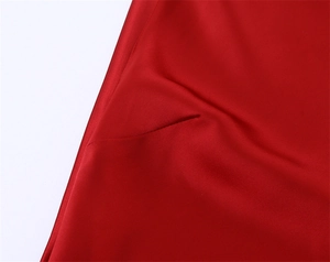 Detailed macro view of the premium red satin fabric texture and high-quality stitching
