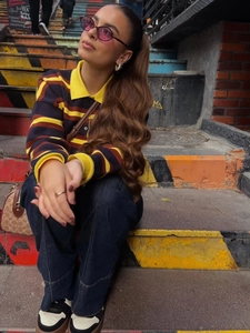 Fashionable POLO neck striped knit top paired with stylish loose jeans and accessories