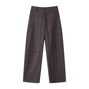 Detailed view of grey plaid wide-leg trousers featuring a high waist and woven texture