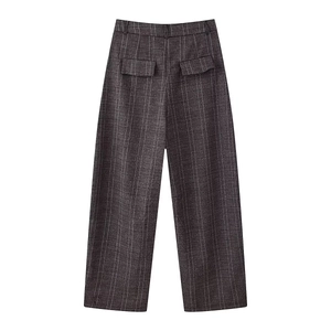 Detail view of plaid wide-leg trousers showing back pockets and belt loops on gray fabric