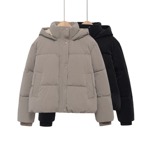 Detail of short hooded puffer jacket with snap closure and elastic cuffs in grey and black