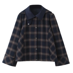 Detail view of plaid jacket featuring contrast navy collar and metallic snap buttons