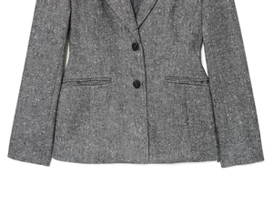Detail of grey herringbone blazer showing single-breasted black buttons and flat pockets