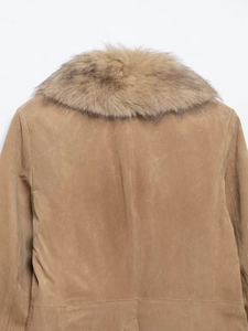 Detail of tan suede jacket featuring high-quality stitching and a plush faux fur collar