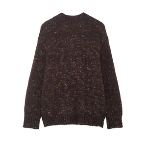 Detail of dark brown knit sweater featuring colorful speckled yarn and ribbed cuffs