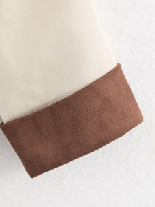 Detail of winter trench coat sleeve with beige fabric and dark brown suede cuffs