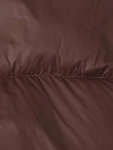 Detailed view of dark brown quilted fabric texture on a winter hooded jacket