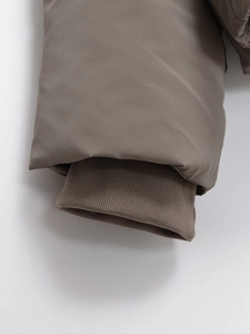 Detail of ribbed windproof cuffs and high-density fabric on a short padded jacket