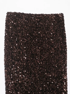 Detailed view of dark brown sequins fabric with reflective texture on a fishtail skirt