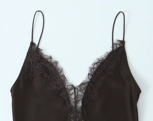 Detailed close-up of dark brown silk satin dress with delicate eyelash lace trim on V-neck