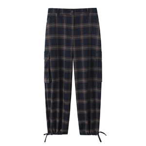 Detail of dark blue plaid cargo pants featuring large side pockets and drawstring cuffs
