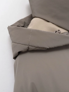 Detail view of precise stitching and durable zipper on this short hooded winter coat