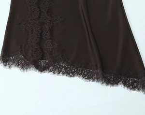 Close-up of chocolate brown satin dress featuring delicate eyelash lace trim detailing