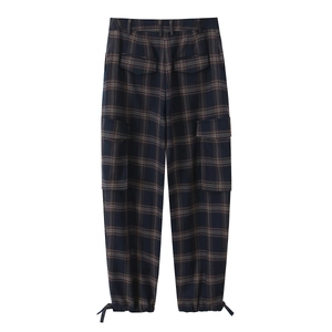 Detail of plaid cargo pants featuring back flap pockets and adjustable drawstring hems