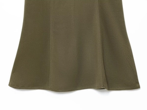 Close-up of olive green knitted dress hem showing fine stitching and premium fabric texture