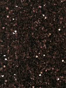 Macro detail of dark brown sequins fabric with metallic luster on long fishtail skirt