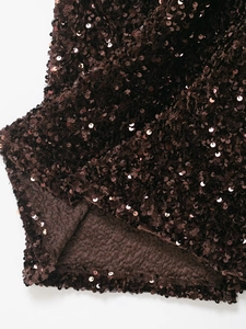 Macro shot of dark brown sequin fabric showing scale-like texture and soft lining