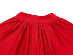 Detailed view of the red long-sleeve shirt showing the pleated waist and fabric texture