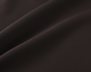 Macro shot of dark satin fabric showing smooth texture and elegant soft folds