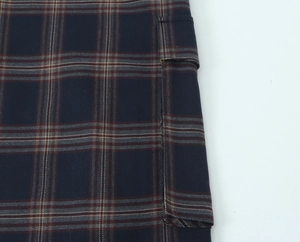 Close-up of classic navy and red plaid jacket fabric with visible metallic thread detail