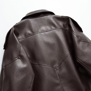 Close-up of the back shoulder seams and collar detail on a brown PU leather jacket