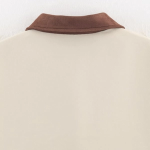 Back view of beige trench jacket featuring dark brown suede collar and precise stitching