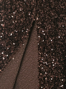 Macro detail of dark brown sequin fabric showing shimmering texture and high-quality stitching