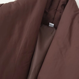 Deep brown quilted winter jacket for women with tie-waist and high-shine puffy finish