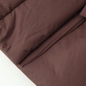 Women's 2025 winter dark brown quilted jacket with belt showing matte nylon texture