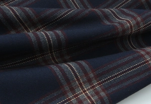 Macro detail of plaid fabric showing dark blue, grey, and burgundy weave textures