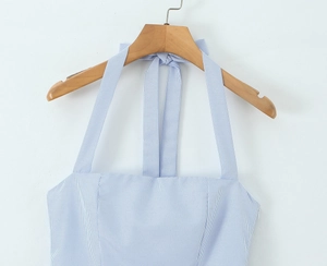 Detail of blue and white striped halter dress featuring side invisible zipper and neat stitching
