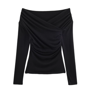 Detailed close-up of the gathered ruching and criss-cross neckline on a black slim-fit top