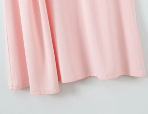 Close-up of light pink dress hem with high-quality double-needle stitching detail
