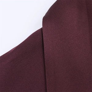 Detailed view of the dark purple satin fabric with a silky texture and smooth sheen