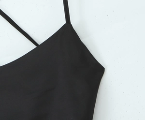Detail of the stitching and shoulder strap connection on a black backless dress