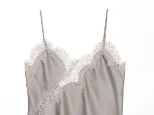 Detail of silk lace camisole showing delicate eyelash lace trim and grey satin fabric texture