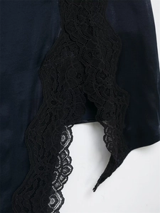 Détail de bordure en dentelle noire élégante avec motifs floraux sur tissu soyeux